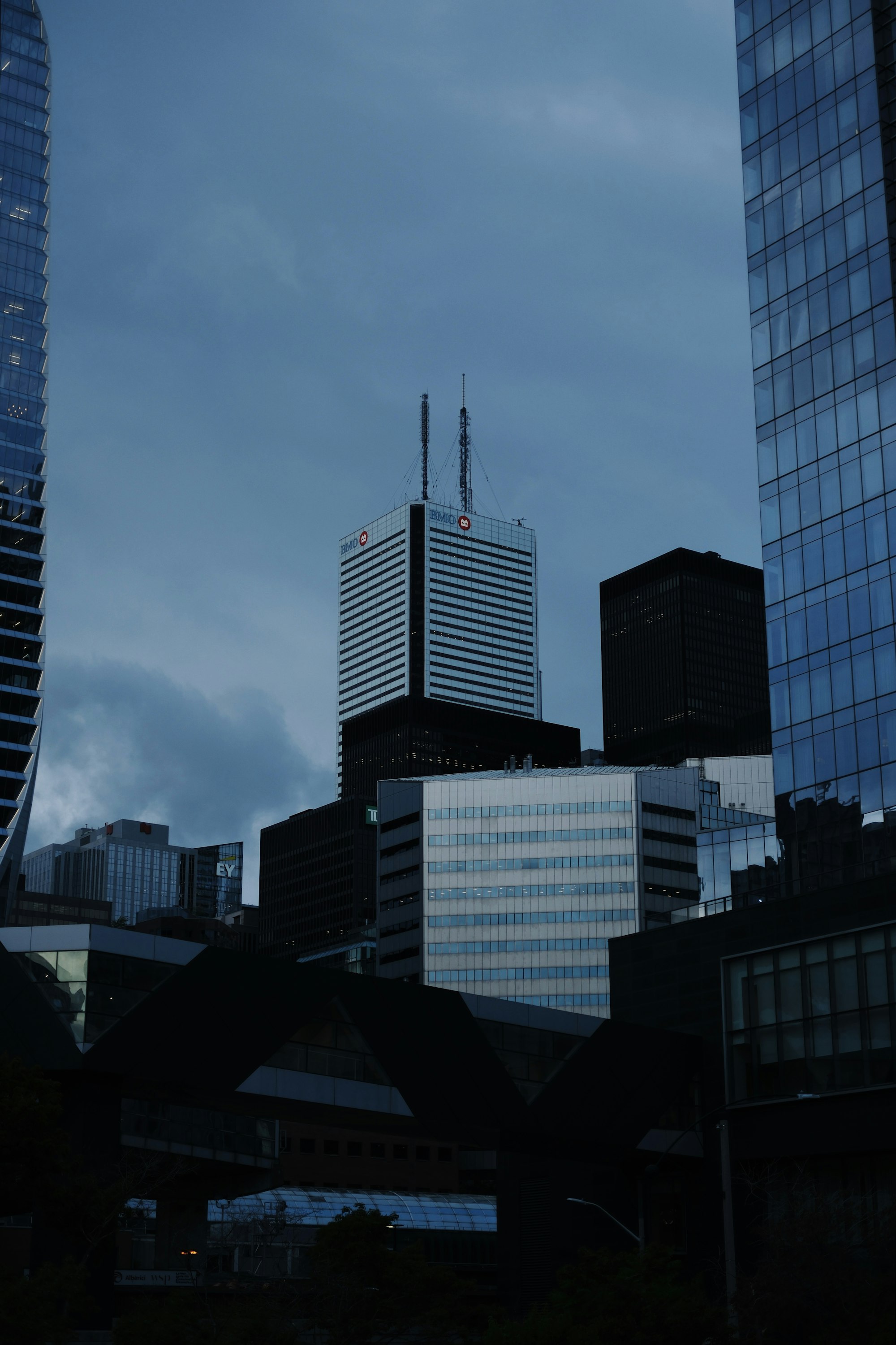 Corporate finance towers rising against an overcast dusk sky